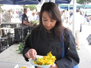 Helena buying zucchini blossoms at the Farmers' Market