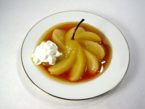 Sliced poached pear with whipped cream