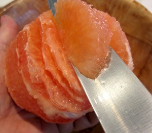 cutting grapefruit segments