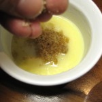 adding brown sugar to a buttered ramekin