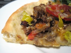 Piece of Philly Cheese Steak Pizza close up