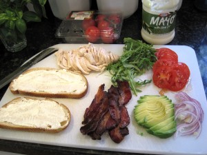 ingredients for a super club sandwich on a cutting board