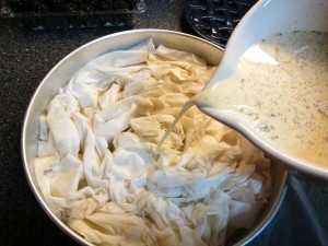 Pouring liquid evenly over phyllo