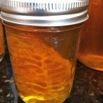 Small jar of fresh honey with comb