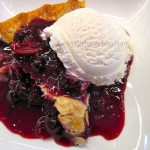 Slice of Warm Blueberry Pie with Vanilla Ice Cream