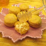 Pouring honey on a buttered pumpkin biscuit